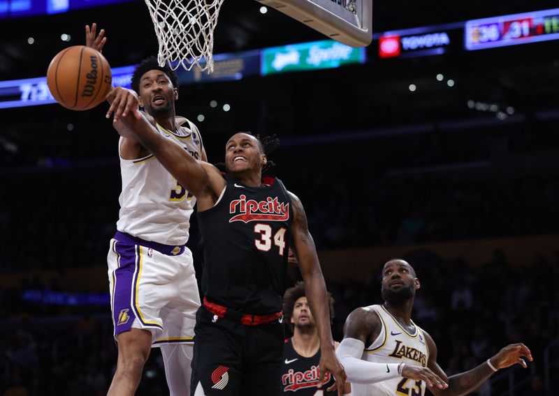 LOS ANGELES, CALIFORNIA - JANUARY 21: Jabari Walker #34 of the Portland Trail Blazers has his shot blocked by Christian Wood #35 of the Los Angeles Lakers during the first half at Crypto.com Arena on January 21, 2024 in Los Angeles, California. User is consenting to the terms and conditions of the Getty Images License Agreement. (Photo by Harry How/Getty Images)