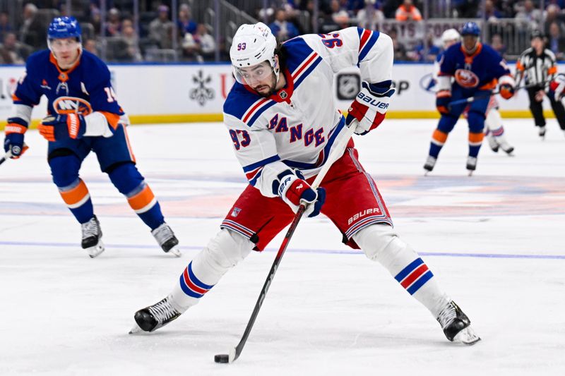 Feb 25, 2025; Elmont, New York, USA;  New York Rangers center Mika Zibanejad (93) skates with the puck against the New York Islanders during the first period at UBS Arena. Mandatory Credit: Dennis Schneidler-Imagn Images