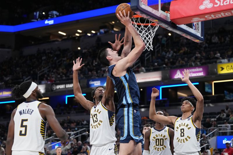 INDIANAPOLIS, INDIANA - OCTOBER 14: Zach Edey #14 of the Memphis Grizzlies lays up a shot against James Wiseman #13 of the Indiana Pacers in the third quarter during a preseason game at Gainbridge Fieldhouse on October 14, 2024 in Indianapolis, Indiana. NOTE TO USER: User expressly acknowledges and agrees that, by downloading and or using this photograph, User is consenting to the terms and conditions of the Getty Images License Agreement. (Photo by Dylan Buell/Getty Images)