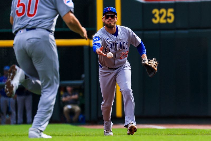 Sep 21, 2025; Cincinnati, Ohio, USA; Chicago Cubs first baseman Michael Busch (29) throws to first to get Cincinnati Reds outfielder Will Benson (not pictured) out in the second inning at Great American Ball Park. Mandatory Credit: Katie Stratman-Imagn Images