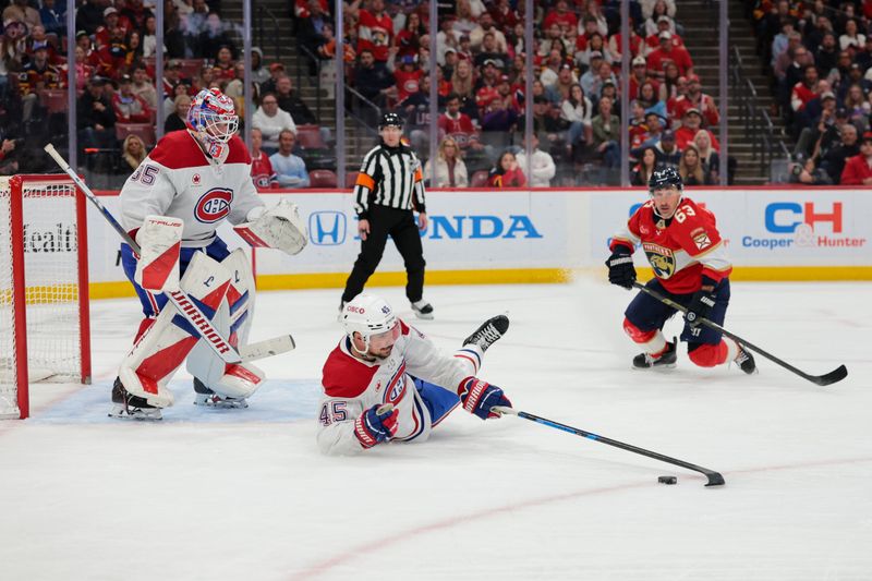 Dec 30, 2025; Sunrise, Florida, USA; Montreal Canadiens defenseman Alexandre Carrier (45) clears the puck against Florida Panthers left wing Brad Marchand (63) during the third period at Amerant Bank Arena. Mandatory Credit: Sam Navarro-Imagn Images