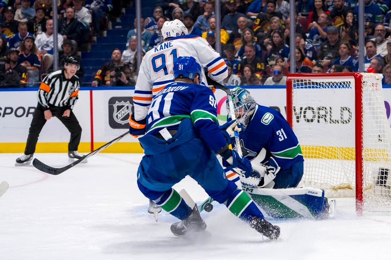 May 20, 2024; Vancouver, British Columbia, CAN; Vancouver Canucks goalie Arturs Silvos (31) makes a save as defenseman Nikita Zadorov (91) battles with Edmonton Oilers forward Evander Kane (91) during the second period in game seven of the second round of the 2024 Stanley Cup Playoffs at Rogers Arena. Mandatory Credit: Bob Frid-USA TODAY Sports