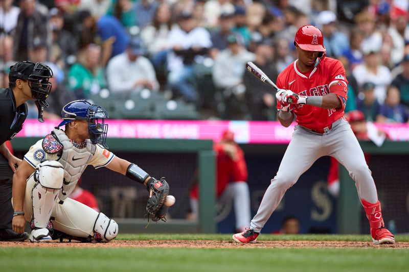 Sep 14, 2025; Seattle, Washington, USA; Seattle Mariners catcher Harry Ford (5) catches as Los Angeles Angels shortstop Denzer Guzman (13) bats during the eighth inning at T-Mobile Park. Mandatory Credit: John Froschauer-Imagn Images