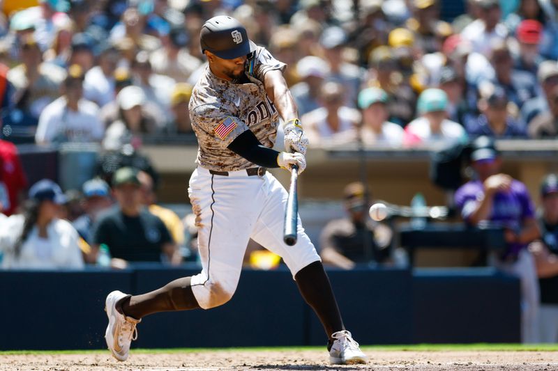 Apr 13, 2025; San Diego, California, USA; San Diego Padres shortstop Xander Bogaerts (2) hits a double during the fifth inning against the Colorado Rockies at Petco Park. Mandatory Credit: David Frerker-Imagn Images