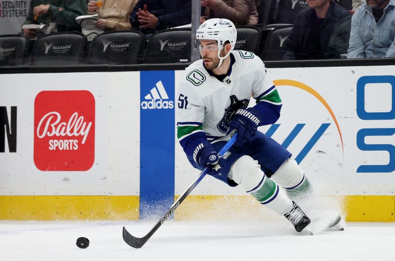 Mar 3, 2024; Anaheim, California, USA; Vancouver Canucks defenseman Mark Friedman (51) controls the puck during the second period against the Anaheim Ducks at Honda Center. Mandatory Credit: Jason Parkhurst-USA TODAY Sports