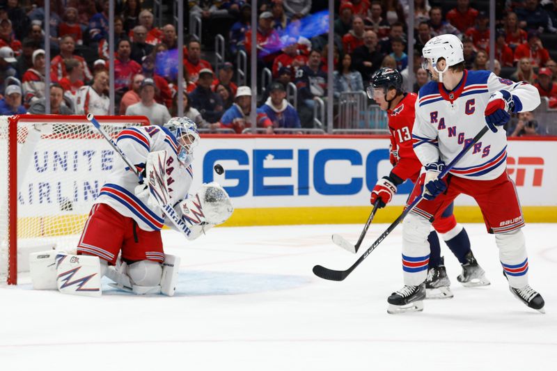 Oct 29, 2024; Washington, District of Columbia, USA; New York Rangers goaltender Igor Shesterkin (31) makes a save on Washington Capitals left wing Jakub Vrana (13) as Rangers defenseman Jacob Trouba (8) defends in the first period at Capital One Arena. Mandatory Credit: Geoff Burke-Imagn Images