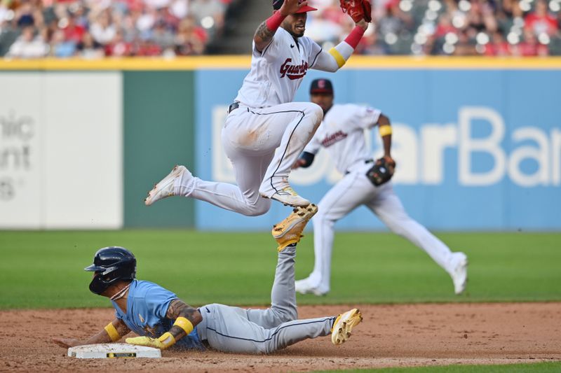 Sep 3, 2023; Cleveland, Ohio, USA; Cleveland Guardians shortstop Gabriel Arias (13) jumps over Tampa Bay Rays center fielder Jose Siri (22) as Siri steals second during the eighth inning at Progressive Field. Mandatory Credit: Ken Blaze-USA TODAY Sports