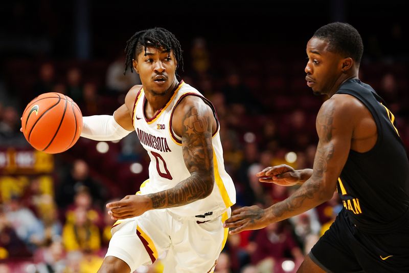 Nov 6, 2023; Minneapolis, Minnesota, USA; Minnesota Golden Gophers guard Elijah Hawkins (0) drives around Bethune-Cookman Wildcats guard Dhashon Dyson (11) during the first half at Williams Arena. Mandatory Credit: Matt Krohn-USA TODAY Sports