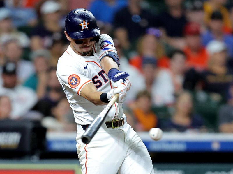 May 22, 2025; Houston, Texas, USA; Houston Astros second baseman Mauricio Dubon (14) hits an RBI single against the Seattle Mariners during the fourth inning at Daikin Park. Mandatory Credit: Erik Williams-Imagn Images