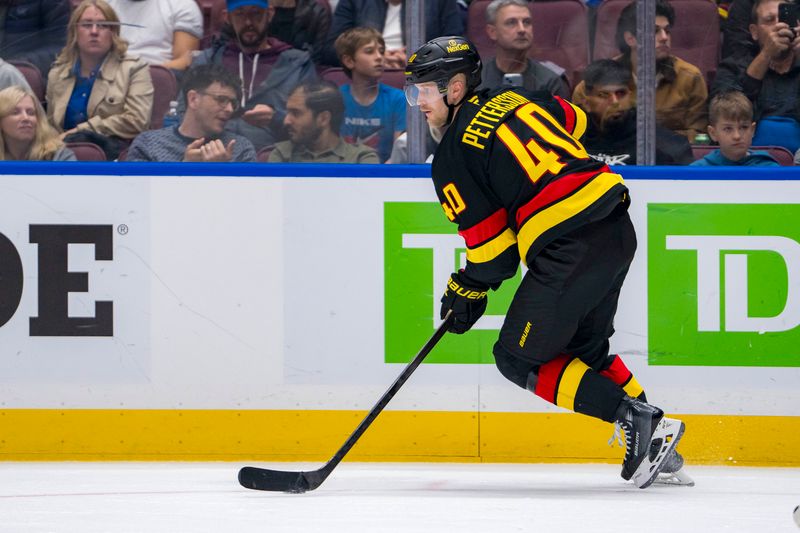 Oct 26, 2024; Vancouver, British Columbia, CAN; Vancouver Canucks forward Elias Pettersson (40) handles the puck against the Pittsburgh Penguins during the third period at Rogers Arena. Mandatory Credit: Bob Frid-Imagn Images