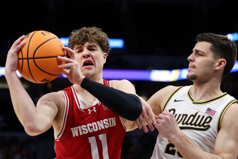 Mar 16, 2024; Minneapolis, MN, USA; Wisconsin Badgers guard Max Klesmit (11) catches a pass as Purdue Boilermakers forward Camden Heide (23) defends during the first half at Target Center. Mandatory Credit: Matt Krohn-USA TODAY Sports