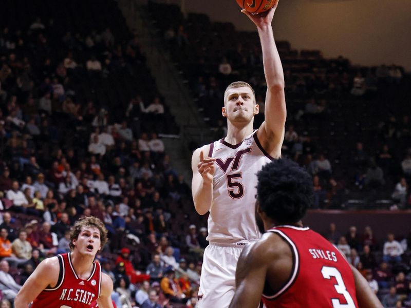 Jan 15, 2025; Blacksburg, Virginia, USA; Virginia Tech Hokies center Patrick Wessler (5) shoots the ball against North Carolina State Wolfpack guard Dontrez Styles (3) during the first half at Cassell Coliseum. Mandatory Credit: Peter Casey-Imagn Images