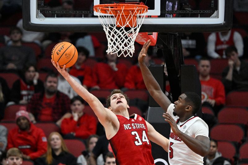 Jan 13, 2024; Louisville, Kentucky, USA;  North Carolina State Wolfpack forward Ben Middlebrooks (34) shoots the ball against Louisville Cardinals forward Brandon Huntley-Hatfield (5) during the second half at KFC Yum! Center.  Mandatory Credit: Jamie Rhodes-USA TODAY Sports