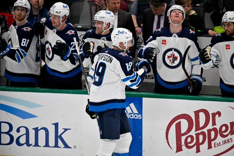 Apr 11, 2024; Dallas, Texas, USA; The Winnipeg Jets bench celebrates a goal scored by center David Gustafsson (19) against the Dallas Stars during the second period at the American Airlines Center. Mandatory Credit: Jerome Miron-USA TODAY Sports