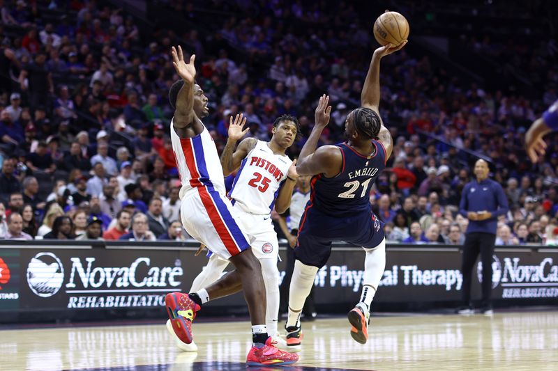 PHILADELPHIA, PENNSYLVANIA - APRIL 09: Joel Embiid #21 of the Philadelphia 76ers shoots over Jalen Duren #0 and Marcus Sasser #25 of the Detroit Pistons during the third quarter at the Wells Fargo Center on April 09, 2024 in Philadelphia, Pennsylvania. (Photo by Tim Nwachukwu/Getty Images)