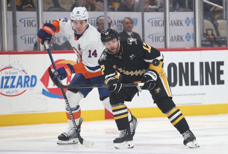 Mar 18, 2025; Pittsburgh, Pennsylvania, USA;  New York Islanders center Bo Horvat (14) and Pittsburgh Penguins right wing Bryan Rust (17) chase the puck during the first period at PPG Paints Arena. Mandatory Credit: Charles LeClaire-Imagn Images