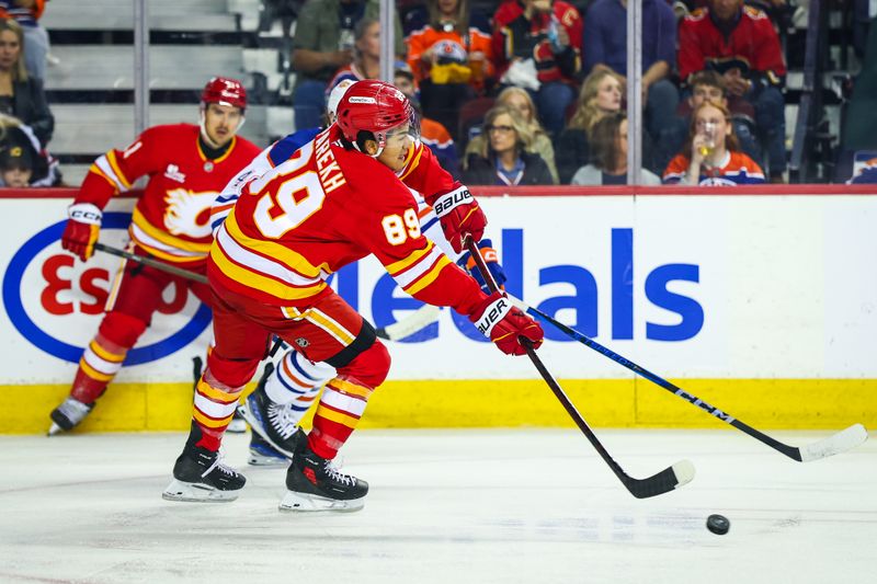 Sep 21, 2025; Calgary, Alberta, CAN; Calgary Flames defenseman Zayne Parekh (89) passes the puck against the Edmonton Oilers during the first period at Scotiabank Saddledome. Mandatory Credit: Sergei Belski-Imagn Images
