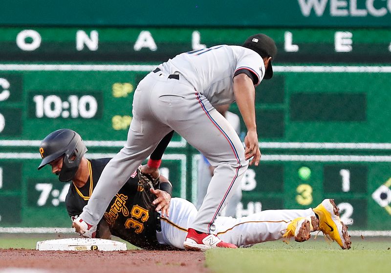 Sep 10, 2024; Pittsburgh, Pennsylvania, USA;  Miami Marlins second baseman Otto Lopez (61) tags Pittsburgh Pirates second baseman Nick Gonzales (39) out at second base on a steal attempt during the second inning at PNC Park. Mandatory Credit: Charles LeClaire-Imagn Images