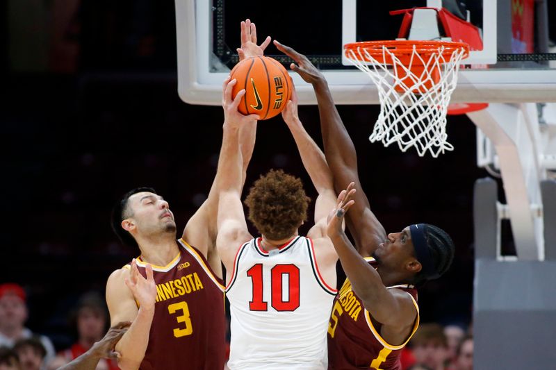 Dec 3, 2023; Columbus, Ohio, USA;  Ohio State Buckeyes forward Jamison Battle (10) takes the ball to the basket as Minnesota Golden Gophers forward Dawson Garcia (3) and forward Isaiah Ihnen (5) defend during the first half at Value City Arena. Mandatory Credit: Joseph Maiorana-USA TODAY Sports