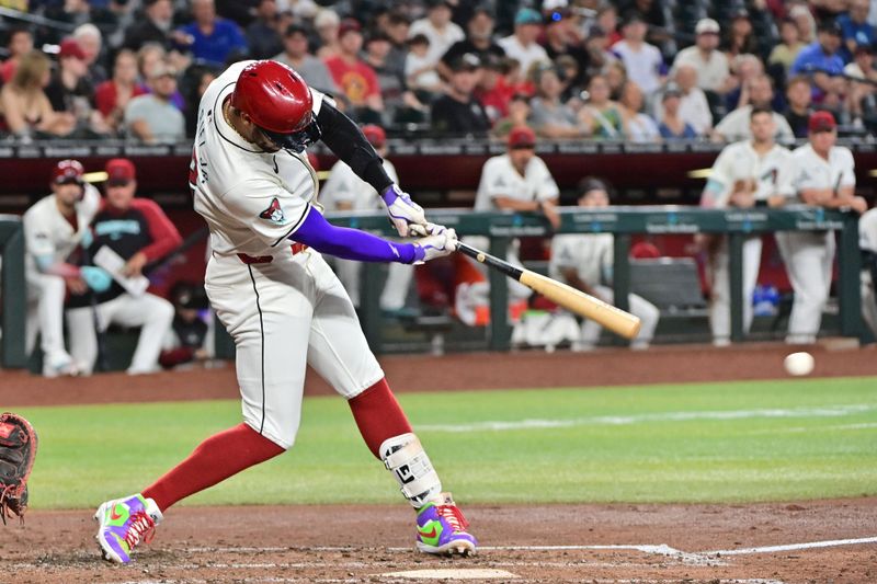 Jul 31, 2024; Phoenix, Arizona, USA;  Arizona Diamondbacks outfielder Lourdes Gurriel Jr. (12) doubles against the Washington Nationals in the third inning at Chase Field. Mandatory Credit: Matt Kartozian-USA TODAY Sports