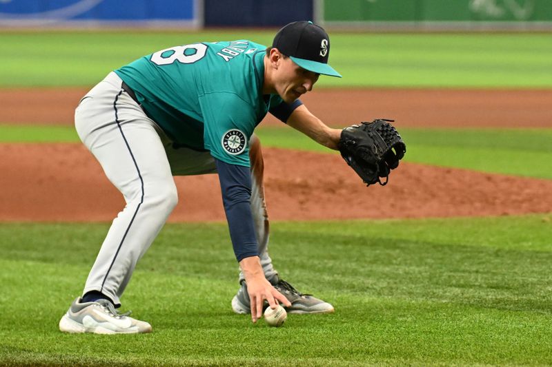 Jun 26, 2024; St. Petersburg, Florida, USA; Seattle Mariners starting pitcher George Kirby (68) fields a bunt against the Tampa Bay Rays in the fifth inning at Tropicana Field. Mandatory Credit: Jonathan Dyer-USA TODAY Sports