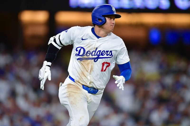 Sep 9, 2024; Los Angeles, California, USA; Los Angeles Dodgers designated hitter Shohei Ohtani (17) runs after hitting a single against the Chicago Cubs during the seventh inning at Dodger Stadium. Mandatory Credit: Gary A. Vasquez-Imagn Images