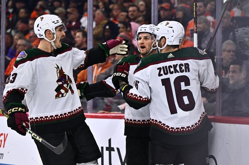 Feb 12, 2024; Philadelphia, Pennsylvania, USA; Arizona Coyotes center Alex Kerfoot (15) celebrates with center Adam Ruzicka (83) and left wing Jason Zucker (16) after scoring a goal against the Philadelphia Flyers in the second period at Wells Fargo Center. Mandatory Credit: Kyle Ross-USA TODAY Sports