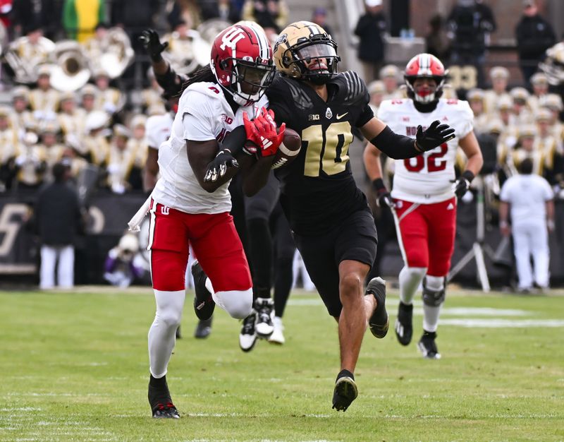 Nov 25, 2023; West Lafayette, Indiana, USA; Purdue Boilermakers defensive back Cam Allen (10) intercepts a pass intended for Indiana Hoosiers wide receiver Andison Coby (0) during the first half at Ross-Ade Stadium. Mandatory Credit: Robert Goddin-USA TODAY Sports