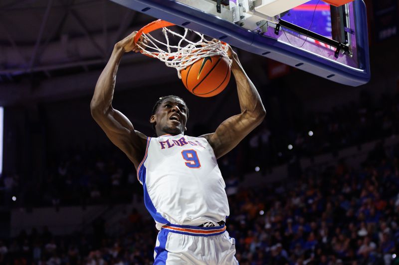 Jan 7, 2025; Gainesville, Florida, USA; Florida Gators center Rueben Chinyelu (9) dunks the ball against the Tennessee Volunteers during the second half at Exactech Arena at the Stephen C. O'Connell Center. Mandatory Credit: Matt Pendleton-Imagn Images