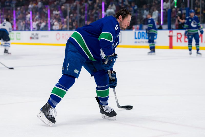 Mar 9, 2024; Vancouver, British Columbia, CAN; Vancouver Canucks forward J.T. Miller (9) shoots during warm up prior to a game against the Winnipeg Jets at Rogers Arena. Mandatory Credit: Bob Frid-USA TODAY Sports