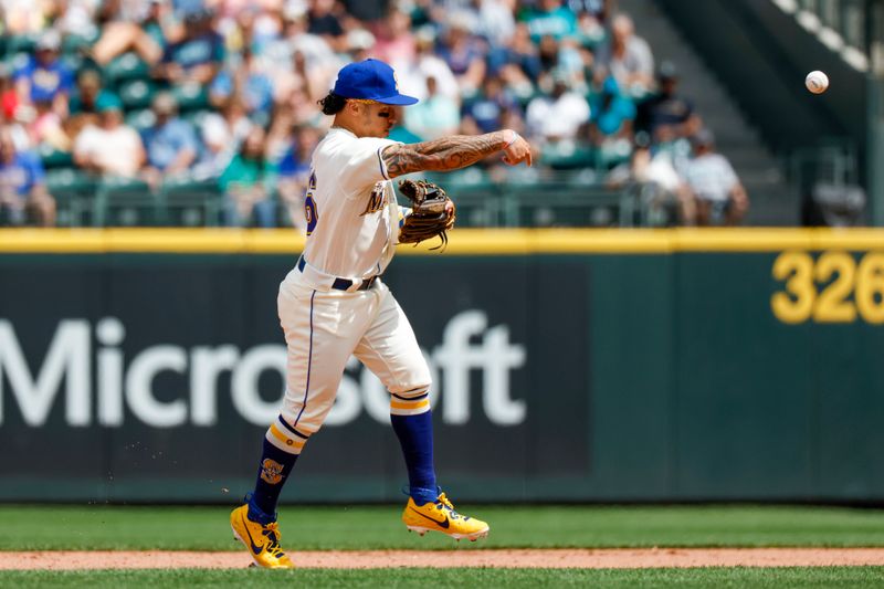 Jul 16, 2023; Seattle, Washington, USA; Seattle Mariners second baseman Kolten Wong (16) throws to first base for a ground out by the Detroit Tigers during the seventh inning at T-Mobile Park. Mandatory Credit: Joe Nicholson-USA TODAY Sports