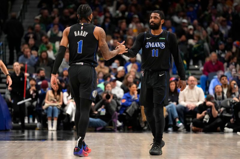 DALLAS, TEXAS - JANUARY 15: Kyrie Irving #11 of the Dallas Mavericks greets Jaden Hardy #1 on the court during a timeout in the first half of the game against the New Orleans Pelicans at American Airlines Center on January 15, 2024 in Dallas, Texas. NOTE TO USER: User expressly acknowledges and agrees that, by downloading and or using this photograph, User is consenting to the terms and conditions of the Getty Images License Agreement. (Photo by Sam Hodde/Getty Images)