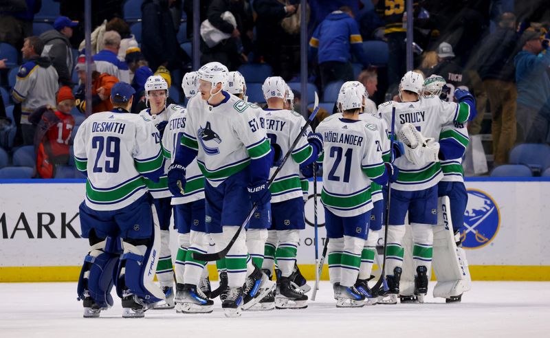 Jan 13, 2024; Buffalo, New York, USA;  The Vancouver Canucks celebrate a win over the Buffalo Sabres at KeyBank Center. Mandatory Credit: Timothy T. Ludwig-USA TODAY Sports