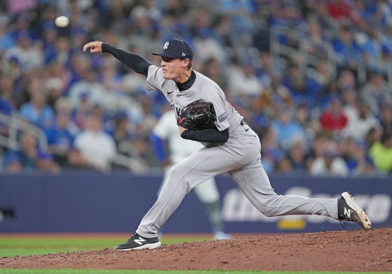 Apr 15, 2024; Toronto, Ontario, CAN; New York Yankees relief pitcher Ron Marinaccio wearing number 42 for Jackie Robinson Day throws a pitch against the Toronto Blue Jays during the sixth inning at Rogers Centre. Mandatory Credit: Nick Turchiaro-USA TODAY Sports