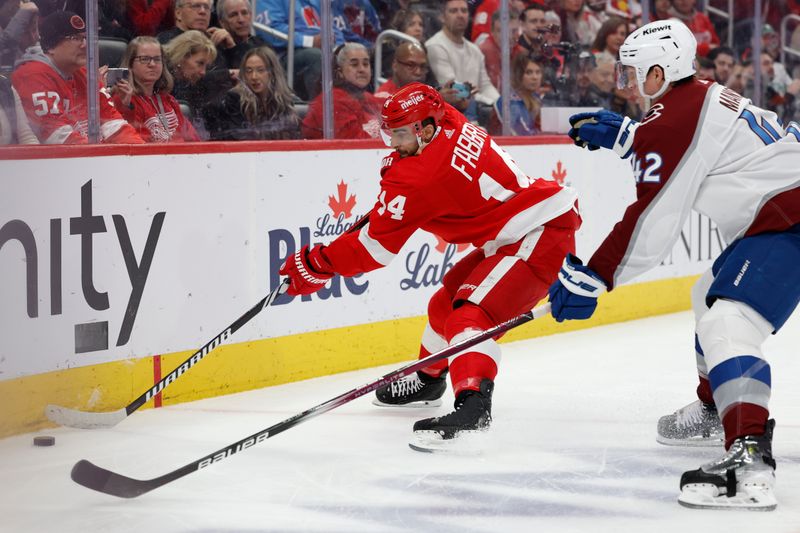 Feb 22, 2024; Detroit, Michigan, USA;  Detroit Red Wings center Robby Fabbri (14) skates with the puck defended by Colorado Avalanche defenseman Josh Manson (42) in the second period at Little Caesars Arena. Mandatory Credit: Rick Osentoski-USA TODAY Sports