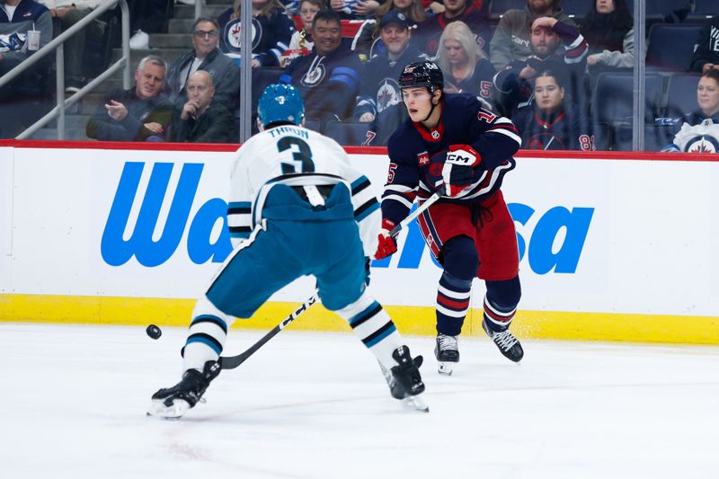 Oct 18, 2024; Winnipeg, Manitoba, CAN;  Winnipeg Jets forward Rasmus Kupari (15) makes a pass by San Jose Sharks defenseman Henry Thrun (3) during the second period at Canada Life Centre. Mandatory Credit: Terrence Lee-Imagn Images