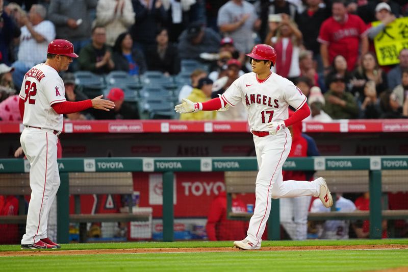 May 24, 2023; Anaheim, California, USA; Los Angeles Angels designated hitter Shohei Ohtani (17) is congratulated by third base coach Bill Haselman (82) after hitting a home run in the third inning against the Boston at Angel Stadium. Mandatory Credit: Kirby Lee-USA TODAY Sports