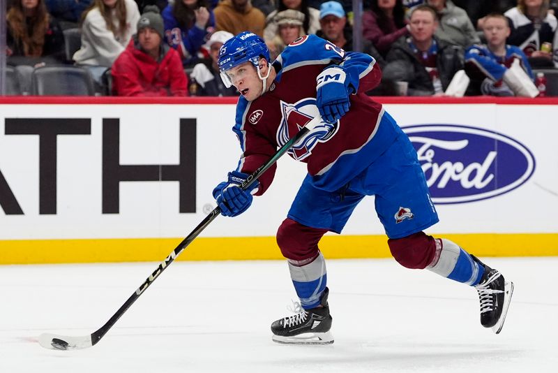 Jan 14, 2025; Denver, Colorado, USA; Colorado Avalanche right wing Logan O'Connor (25) shoots the puck in the second period against the New York Rangers at Ball Arena. Mandatory Credit: Ron Chenoy-Imagn Images