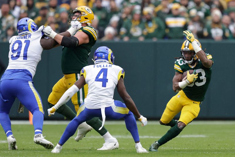 Green Bay Packers running back Aaron Jones (33), right, runs with the football during the first half of an NFL football game against the Los Angeles Rams, Sunday, Nov. 5, 2023, in Green Bay, Wis. (AP Photo/Matt Ludtke)