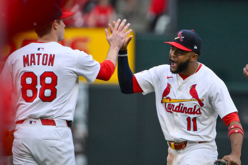 May 25, 2025; St. Louis, Missouri, USA;  St. Louis Cardinals center fielder Victor Scott II (11) celebrates with relief pitcher Phil Maton (88) after the Cardinals defeated the Arizona Diamondbacks at Busch Stadium. Mandatory Credit: Jeff Curry-Imagn Images