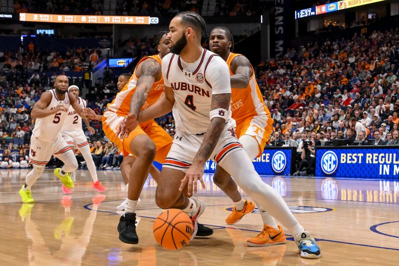 Mar 15, 2025; Nashville, TN, USA;  Auburn Tigers forward Johni Broome (4) dribbles the ball against the Tennessee Volunteers during the first half at Bridgestone Arena. Mandatory Credit: Steve Roberts-Imagn Images