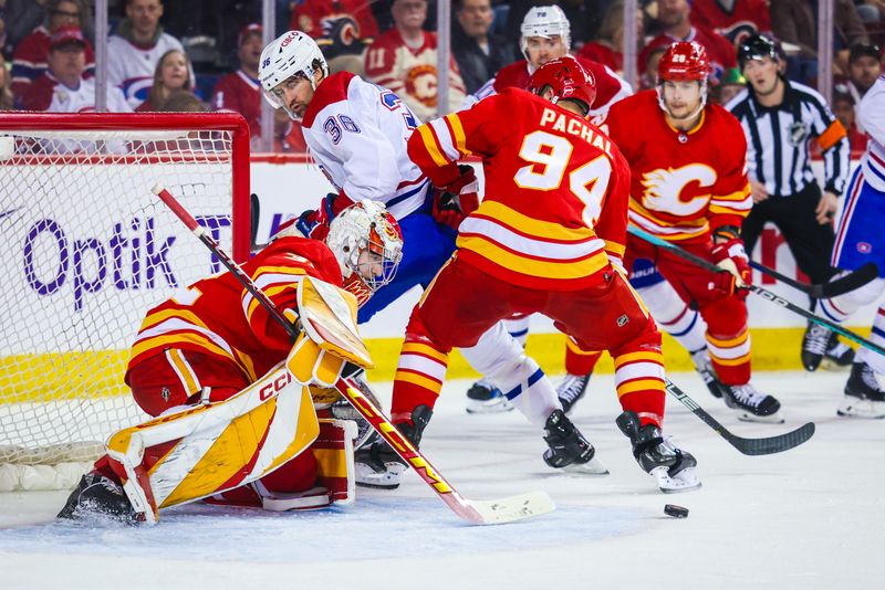 Mar 16, 2024; Calgary, Alberta, CAN; Calgary Flames goaltender Dustin Wolf (32) makes a save against the Montreal Canadiens during the first period at Scotiabank Saddledome. Mandatory Credit: Sergei Belski-USA TODAY Sports