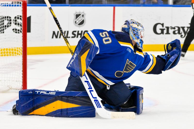 Nov 21, 2024; St. Louis, Missouri, USA;  St. Louis Blues goaltender Jordan Binnington (50) defends the net against the San Jose Sharks during the third period at Enterprise Center. Mandatory Credit: Jeff Curry-Imagn Images