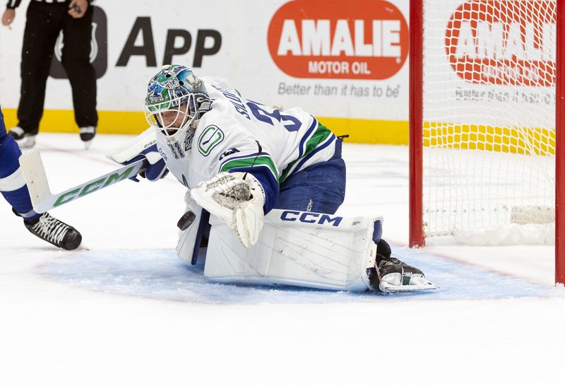 Oct 15, 2024; Tampa, Florida, USA; Vancouver Canucks goaltender Arturs Silovs (31) makes a save against the Tampa Bay Lightning during the first period at Amalie Arena. Mandatory Credit: Kim Klement Neitzel-Imagn Images