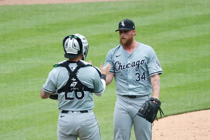 Jun 22, 2024; Detroit, Michigan, USA;  Chicago White Sox catcher Korey Lee (26) and relief pitcher Michael Kopech (34) celebrate after defeating the Detroit Tigers at Comerica Park. Mandatory Credit: Rick Osentoski-USA TODAY Sports