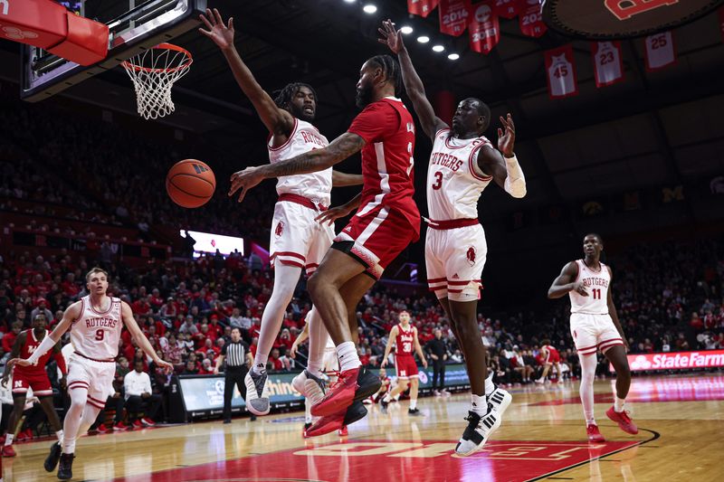 Jan 17, 2024; Piscataway, New Jersey, USA; Nebraska Cornhuskers guard Brice Williams (3) passes the ball as Rutgers Scarlet Knights forward Mawot Mag (3) and guard Austin Williams (24) defend during the first half at Jersey Mike's Arena. Mandatory Credit: Vincent Carchietta-USA TODAY Sports