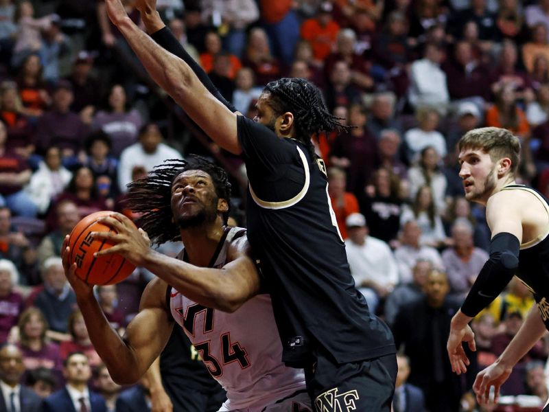 Mar 2, 2024; Blacksburg, Virginia, USA; Virginia Tech Hokies forward Mylyjael Poteat (34) shoots the ball against Wake Forest Demon Deacons forward Efton Reid III (4) during the second half at Cassell Coliseum. Mandatory Credit: Peter Casey-USA TODAY Sports