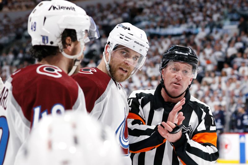 Apr 30, 2024; Winnipeg, Manitoba, CAN; Referee Kelly Sutherland (11) discusses a call with Colorado Avalanche defenseman Devon Toews (7) in the second period against the Winnipeg Jets in game five of the first round of the 2024 Stanley Cup Playoffs at Canada Life Centre. Mandatory Credit: James Carey Lauder-USA TODAY Sports