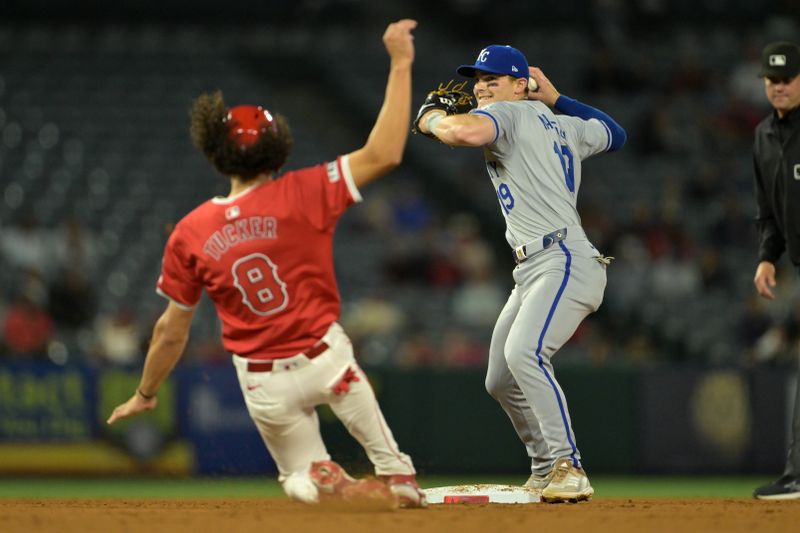 May 9, 2024; Anaheim, California, USA; Kansas City Royals shortstop Bobby Witt Jr. (7) throws to first as Los Angeles Angels shortstop Cole Tucker (8) is out at second on a double play in the eighth inning at Angel Stadium. Mandatory Credit: Jayne Kamin-Oncea-USA TODAY Sports