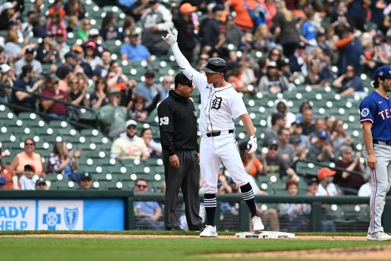 Apr 18, 2024; Detroit, Michigan, USA;  Detroit Tigers designated hitter Kerry Carpenter (30) celebrates at third base after hitting a triple against the Texas Rangers in the fourth inning at Comerica Park. Mandatory Credit: Lon Horwedel-USA TODAY Sports